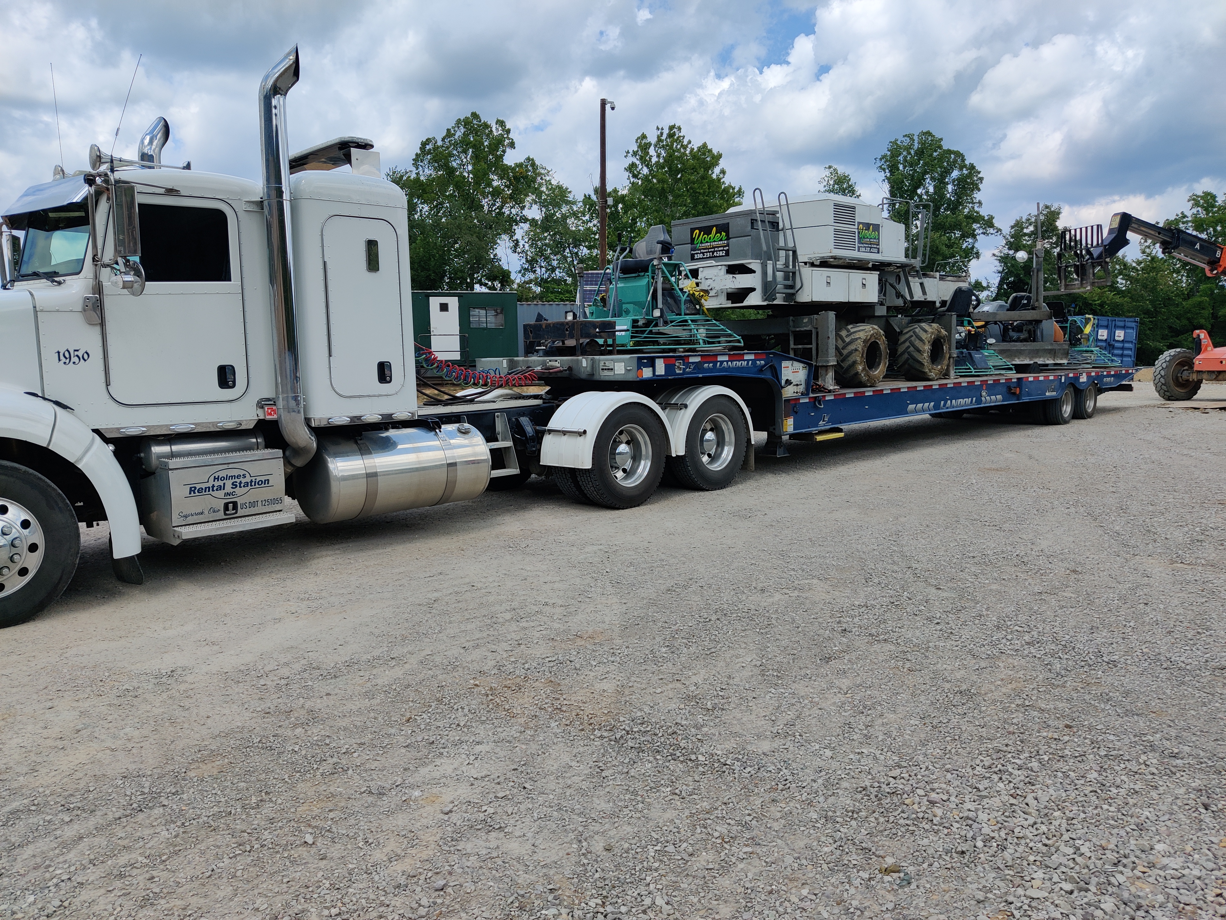 Somero laser screed loaded on a Yoder Laser Concrete lowboy trailer for transport