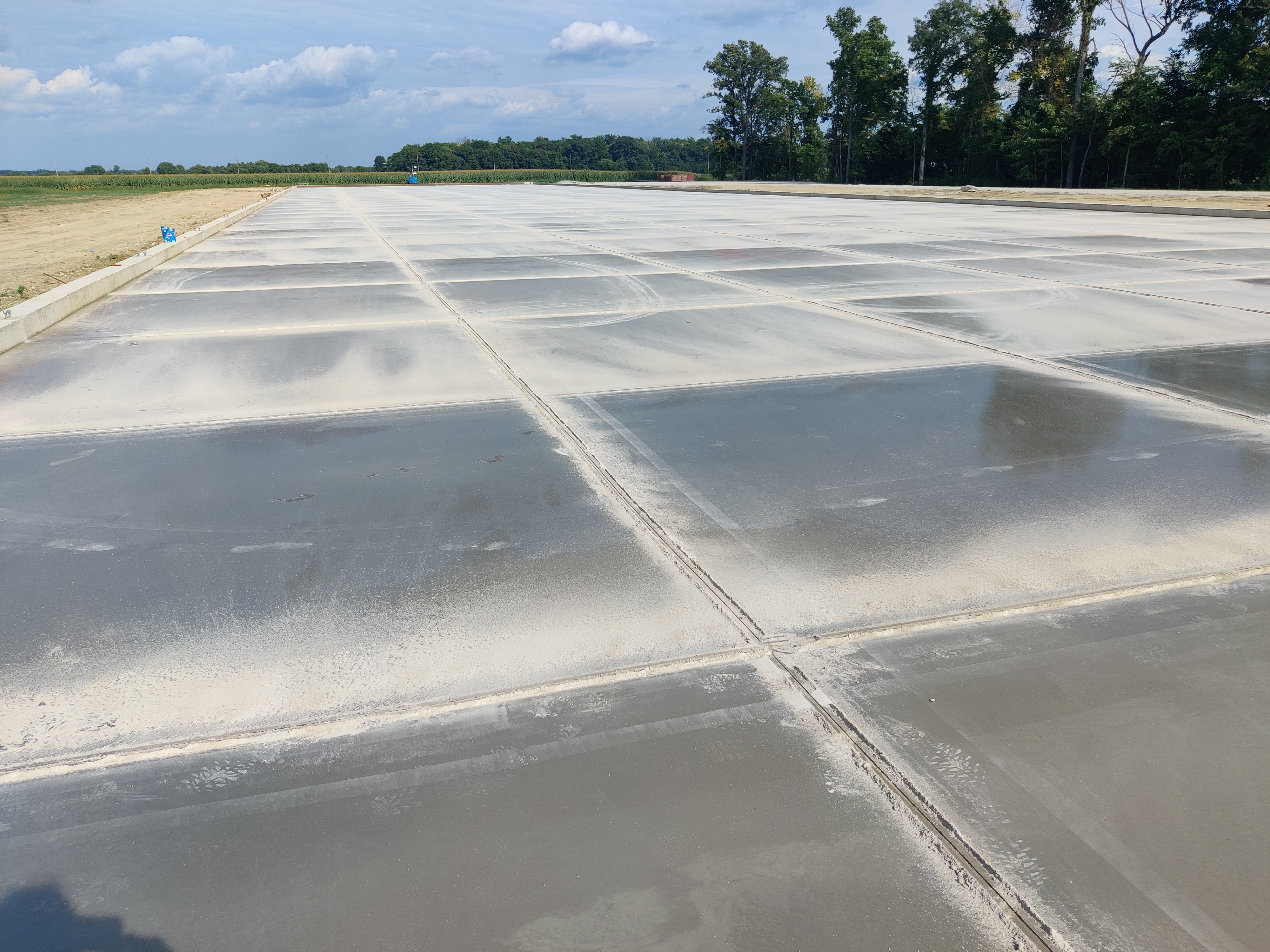 Finished commercial concrete pad showing the sawn joint pattern across the slab