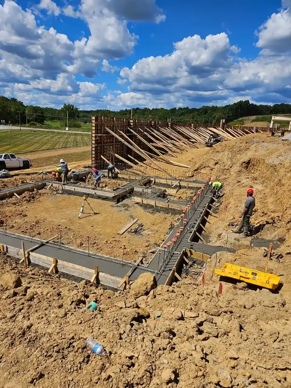 Formed concrete foundation walls standing over poured footings on a commercial build