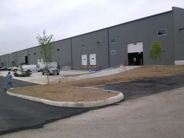 Completed commercial building with a finished concrete apron and drive