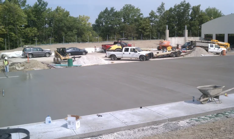 Large finished commercial concrete pad and apron outside a new building