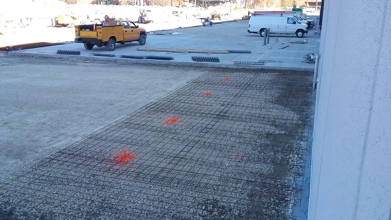 Reinforcing steel mat laid out on prepared subgrade for a commercial concrete pad