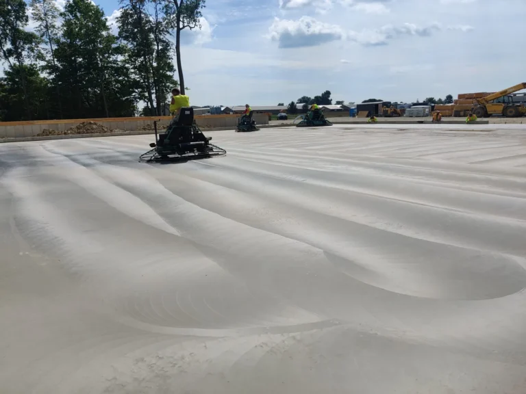 Ride-on power trowels finishing a large commercial concrete slab