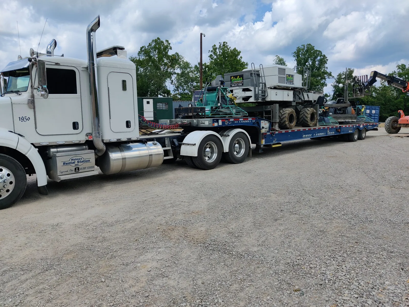 Somero laser screed loaded on a Yoder Laser Concrete lowboy trailer for transport