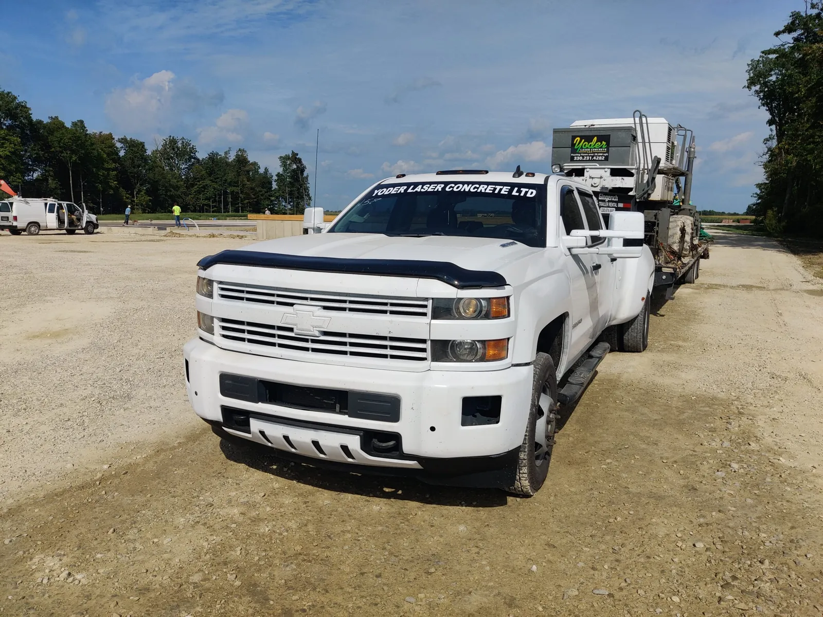 Yoder Laser Concrete truck and a ready-mix mixer staged on a commercial site